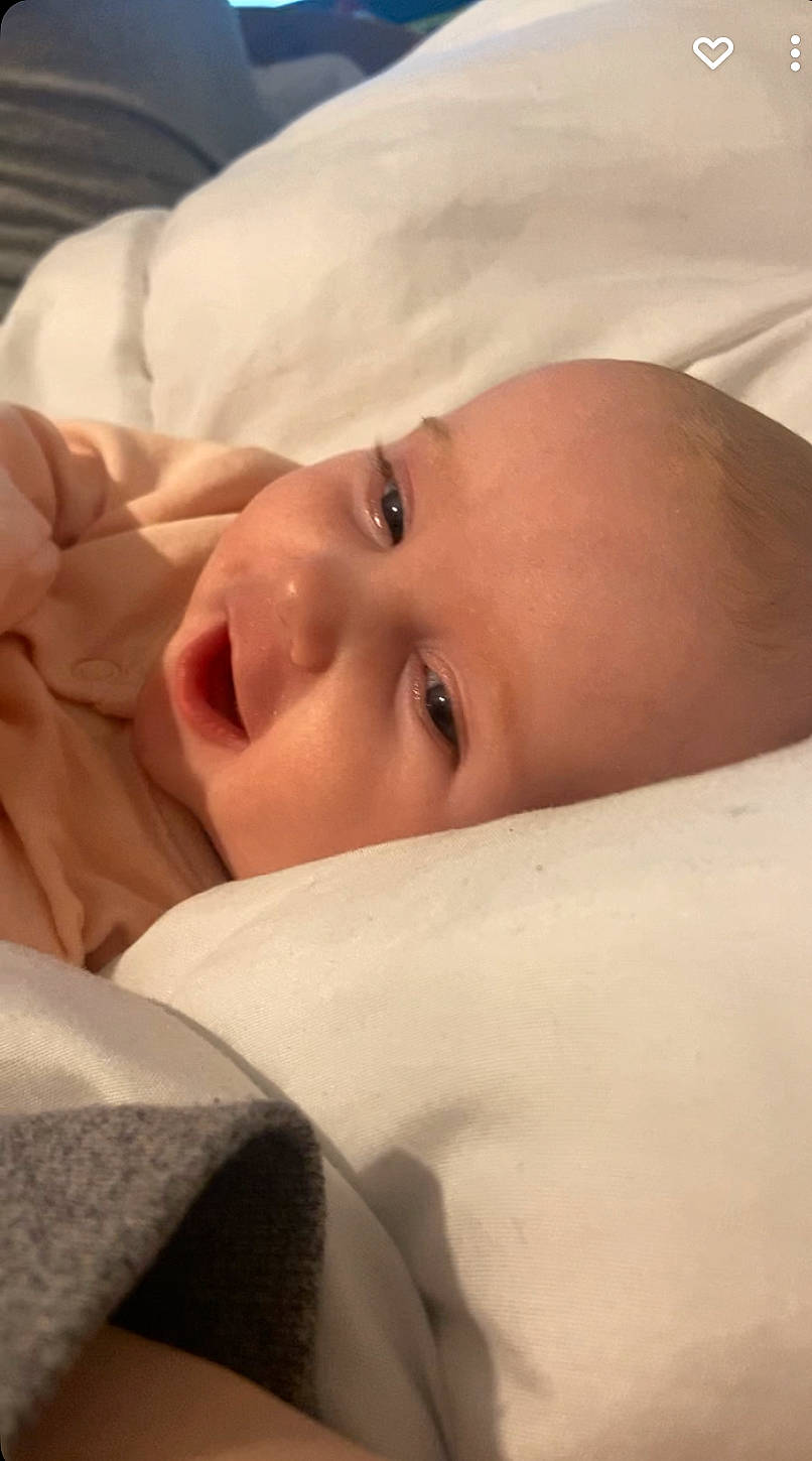 Kayleigh is registered to the contest to win money with this photo: baby, cheek, child, chin, close_up, comfort, eye, eyebrow, eyelash, face, finger, linens, lip, mammal, mouth, neck, nose, person, skin, toddler