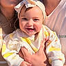 baby, child, smiling, headband, bow, hands, clothing, person, adult, family, portrait, closeup, happy, skin, face, sunlight, casual, tshirt, indoor, warm
