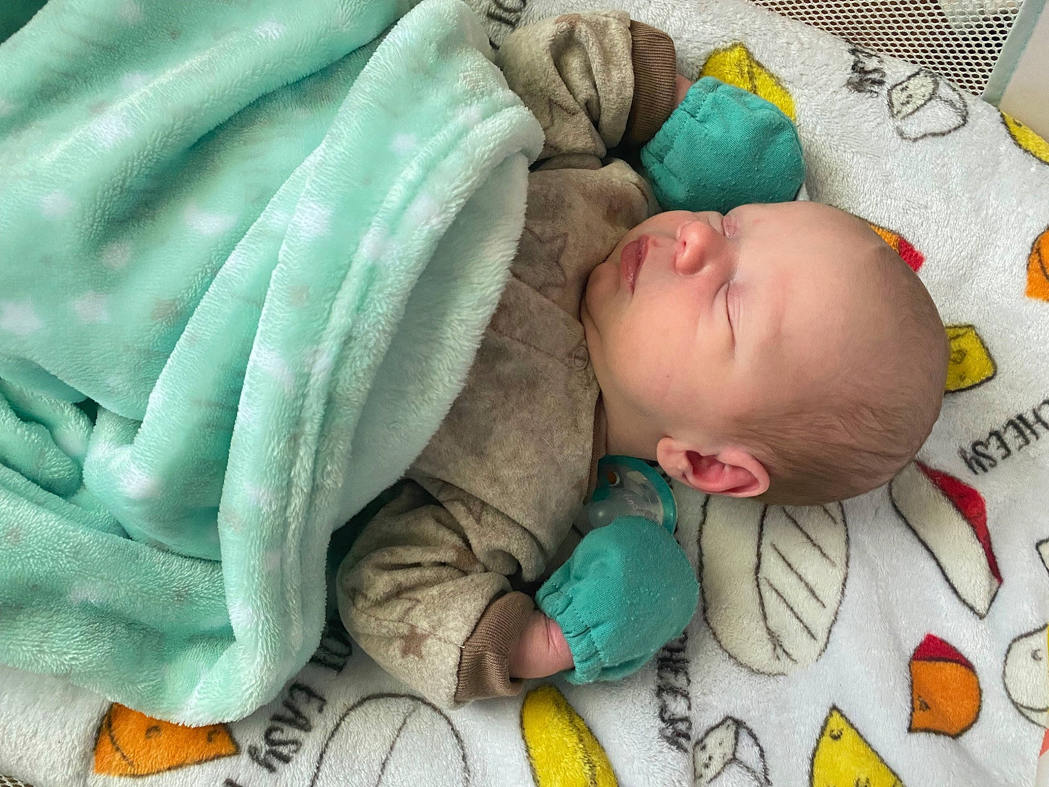Aiden joined the competition — help win amazing prizes! baby, baby_products, baby_safety, baby_sleeping, baby_toddler_clothing, baby_toys, bedding, bedtime, cheek, comfort, facial_expression, green, infant_bed, linens, nap, person, product, room, skin, textile
