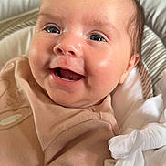 Hallie is registered to the contest to win money with this photo: baby, child, closeup, clothing, cushion, cute, eyes, face, happy, head, indoors, infant, joy, mouth, newborn, person, seated, skin, smile, soft