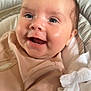 baby, child, closeup, clothing, cushion, cute, eyes, face, happy, head, indoors, infant, joy, mouth, newborn, person, seated, skin, smile, soft