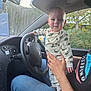 Wesley joined the competition — help win amazing prizes! baby, child, dinosaur_pajamas, car_interior, steering_wheel, hand, adult, denim_jeans, window, greenery, trees, seat, smiling, face, foot, clothing, dashboard, mirror, casual, playful