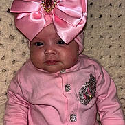 Kadjira participe au concours pour gagner de l'argent avec cette photo : baby, pink_outfit, headband, bow, sparkle, blanket, cute, infant, portrait, child, clothing, face, hand, sitting, indoor, young_child, soft_texture, cute_expression, adorable, warm_lighting