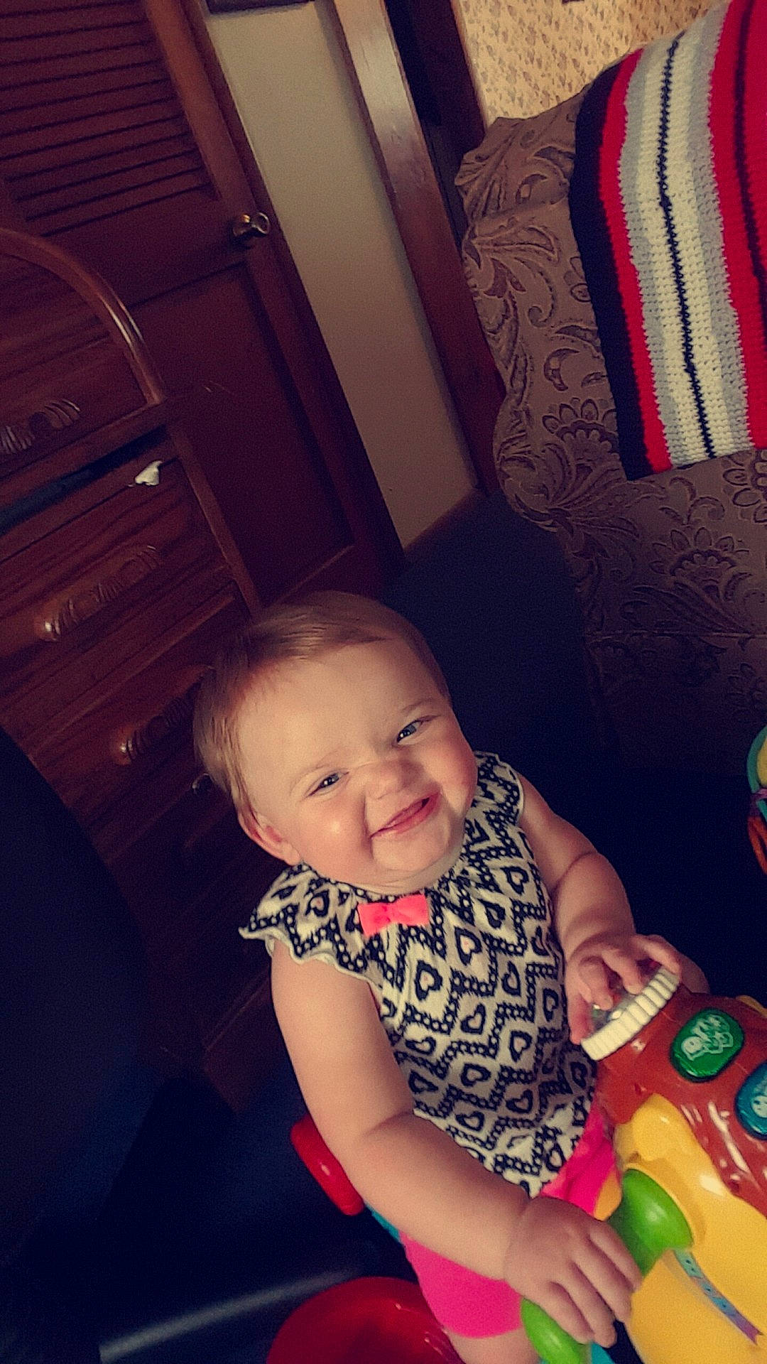 Olivia is registered to the contest to win money with this photo: child, day, ear, eye, fun, girl, happiness, infant, joy, organ, person, pink, sitting, skin, smile, snapshot, toddler