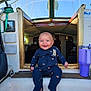 baby, smiling, onesie, boat, cabin, window, doorway, tumbler, purple, seat, nautical, interior, child, blue_eyes, happy, sitting, indoor, wood, rope, star_pattern