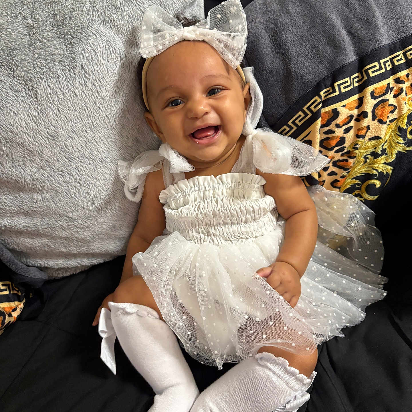 Keyahbri is registered to the contest to win money with this photo: baby, bow, child, cozy, cute, dress, fabric, happy, headband, indoor, infant, person, pillow, polka_dot, portrait, sitting, smiling, socks, soft, white