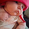 Timburlee is registered to the contest to win money with this photo: arm, baby, bib, candid, child, close_up, clothing, eyes, face, hand, hat, indoors, infant, photography, pink_hat, portrait, pout, rosy_cheeks, sitting, soft_lighting