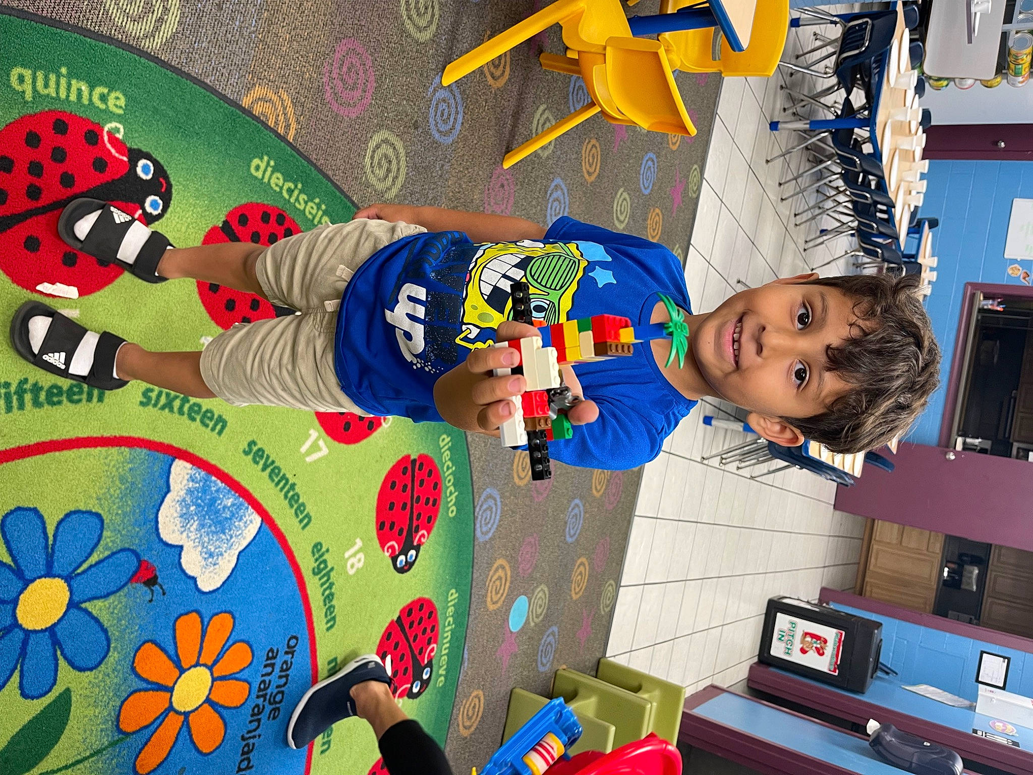 Carlos is registered to the contest to win money with this photo: art, blue, child, flower, fun, happy, joy, leisure, machine, pattern, person, play, product, red, room, smile, space, t_shirt, textile, toddler