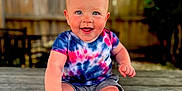 Owen joined the competition — help win amazing prizes! baby, barefoot, child, cute, daylight, face, fence, greenery, happy, nature, outdoor, portrait, shorts, sitting, skin, smiling, sunlight, tie_dye_shirt, wooden_deck, young_child