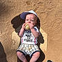 baby, baseball, cap, child, sportswear, home_plate, sand, shadow, sneaker, outdoor, sunlight, cute, infant, grip, shorts, shirt, play, ball, feet, person