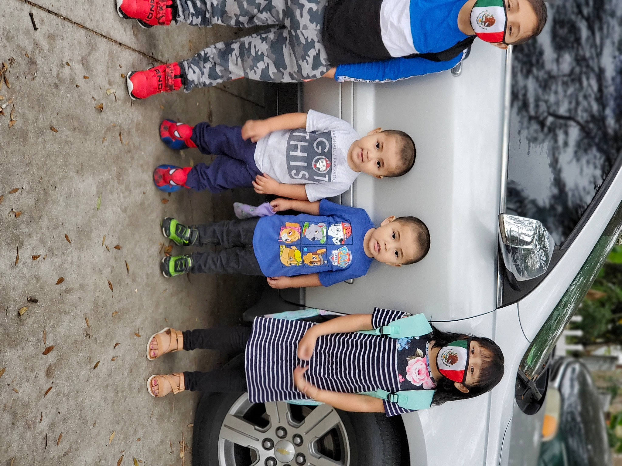 Emma-jean is registered to the contest to win money with this photo: alloy_wheel, auto_part, automotive_exterior, automotive_tire, automotive_wheel_system, automotive_window_part, baby_toddler_clothing, child, fender, foot, hubcap, person, rim, sand, slipper, synthetic_rubber, tire_care, toddler, tread, vehicle_door