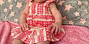 Payton joined the competition — help win amazing prizes! baby, child, dress, pink, patterned_clothing, socks, bow, blanket, star_pattern, gray, cozy, cute, portrait, indoor, infant, sitting, expression, hands, feet, soft_texture