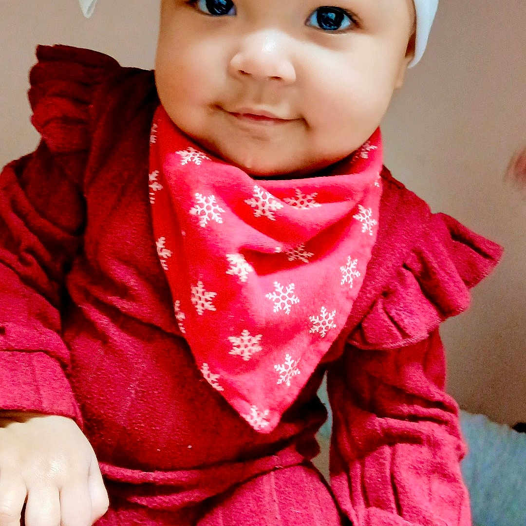 Airalyse is registered to the contest to win money with this photo: baby, bandana, bed, big_eyes, blanket, bow, cheeks, child, cute, festive, hand, headband, indoor, infant, portrait, red_outfit, red_sweater, sitting, smile, socks