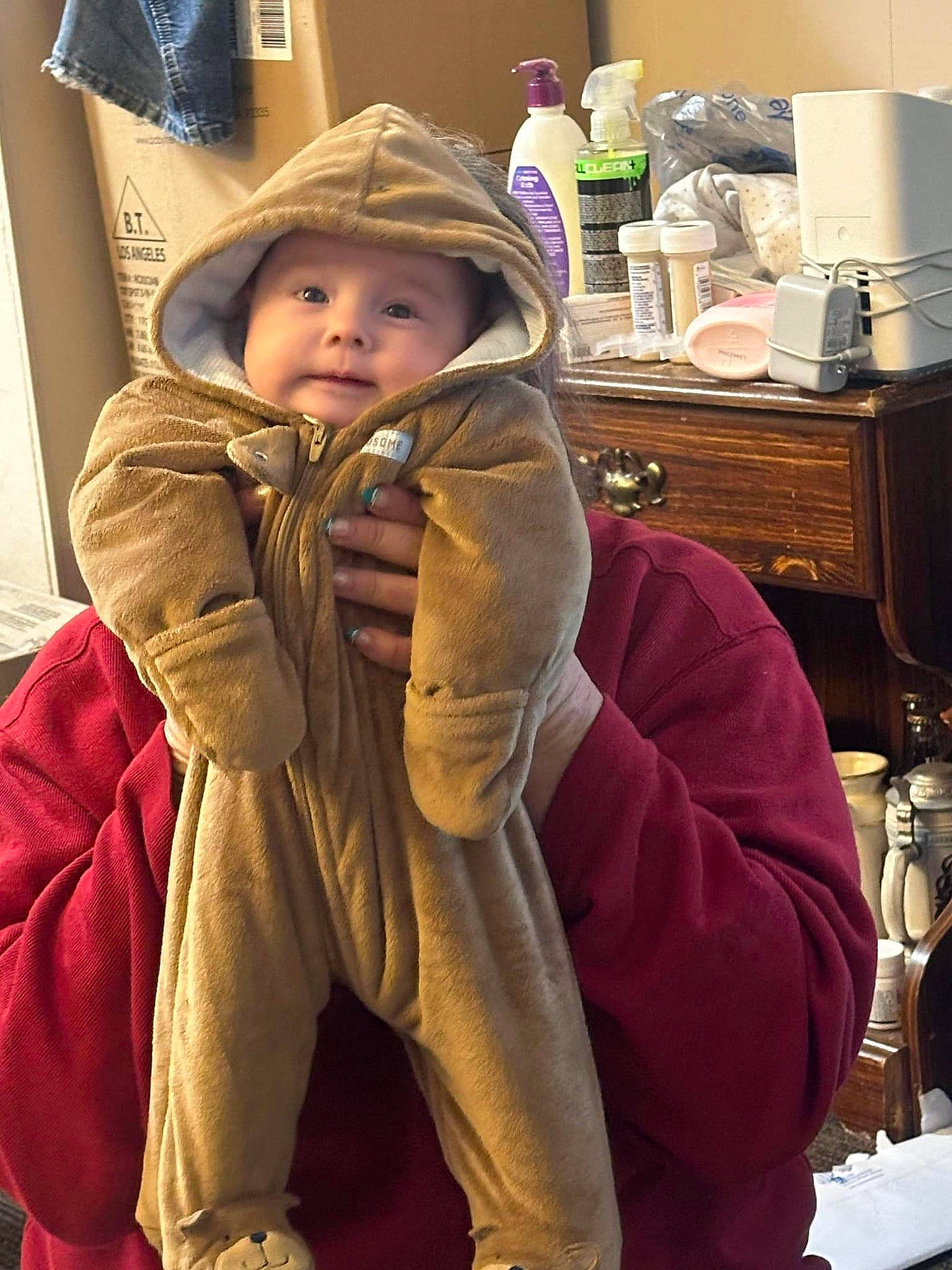 Nova is registered to the contest to win money with this photo: baby, baby_toddler_clothing, cheek, child, comfort, flooring, fun, fur, fur_clothing, headwear, home_appliance, jacket, kitchen_appliance, paper_towel, person, personal_protective_equipment, room, sitting, sleeve, tableware