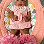 Malani is registered to the contest to win money with this photo: baby, infant, pink_dress, headband, flower, baby_lounger, cushion, pattern, frilly_socks, white_socks, cute, child, indoors, soft_fabric, comfort, portrait, smile, skin, person, happy