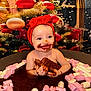 baby, child, red_headband, bow, chocolate, marshmallows, messy, smiling, happy, tub, food_play, face_paint, festive_background, indoors, cute, playing, sweet, hands, sitting, fun