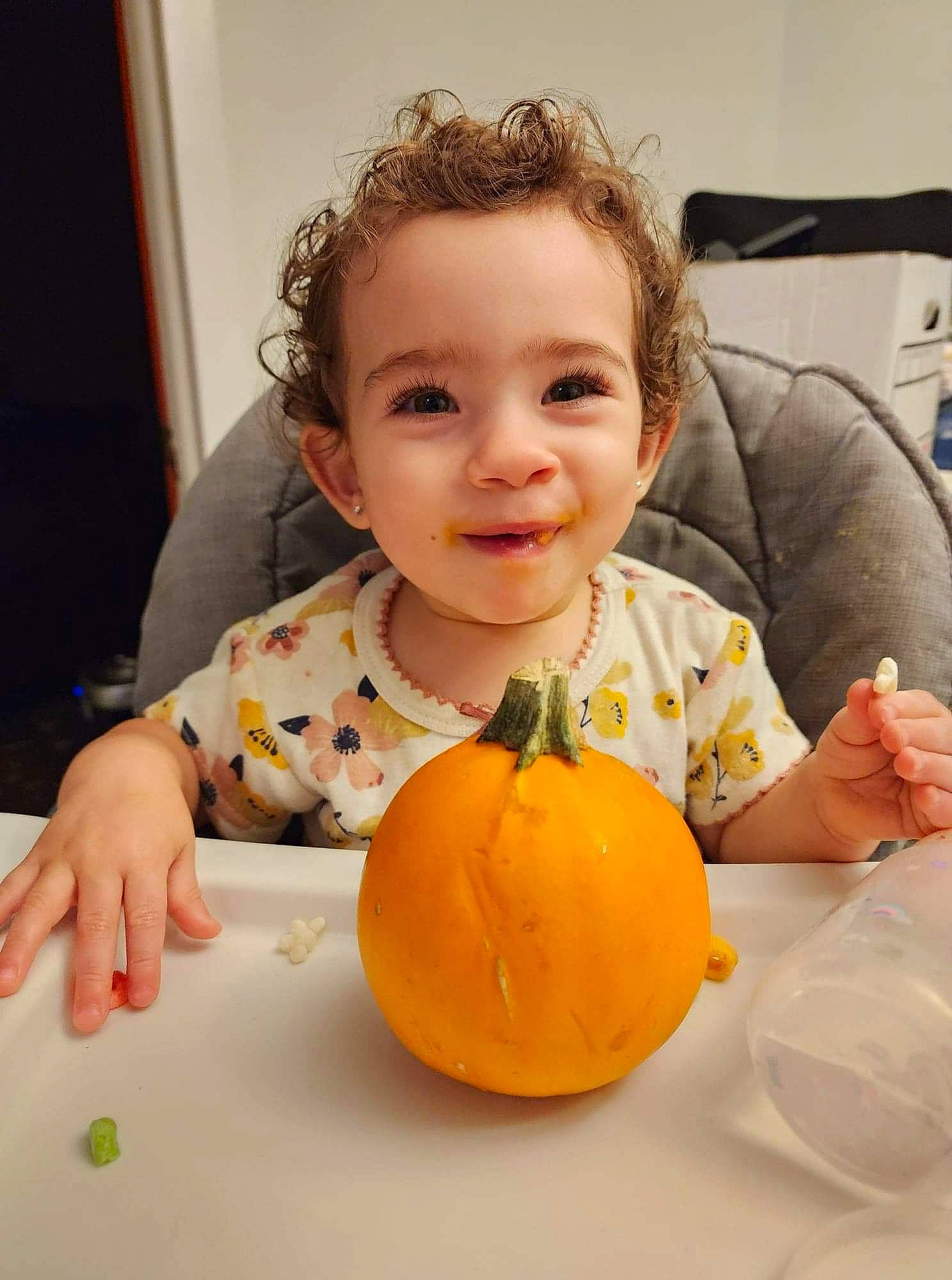 Arianna is registered to the contest to win money with this photo: calabaza, cheek, child, cucurbita, dress, eye, face, finger, hand, happy, head, orange, person, plant, pumpkin, smile, squash, table, toddler, vegetable