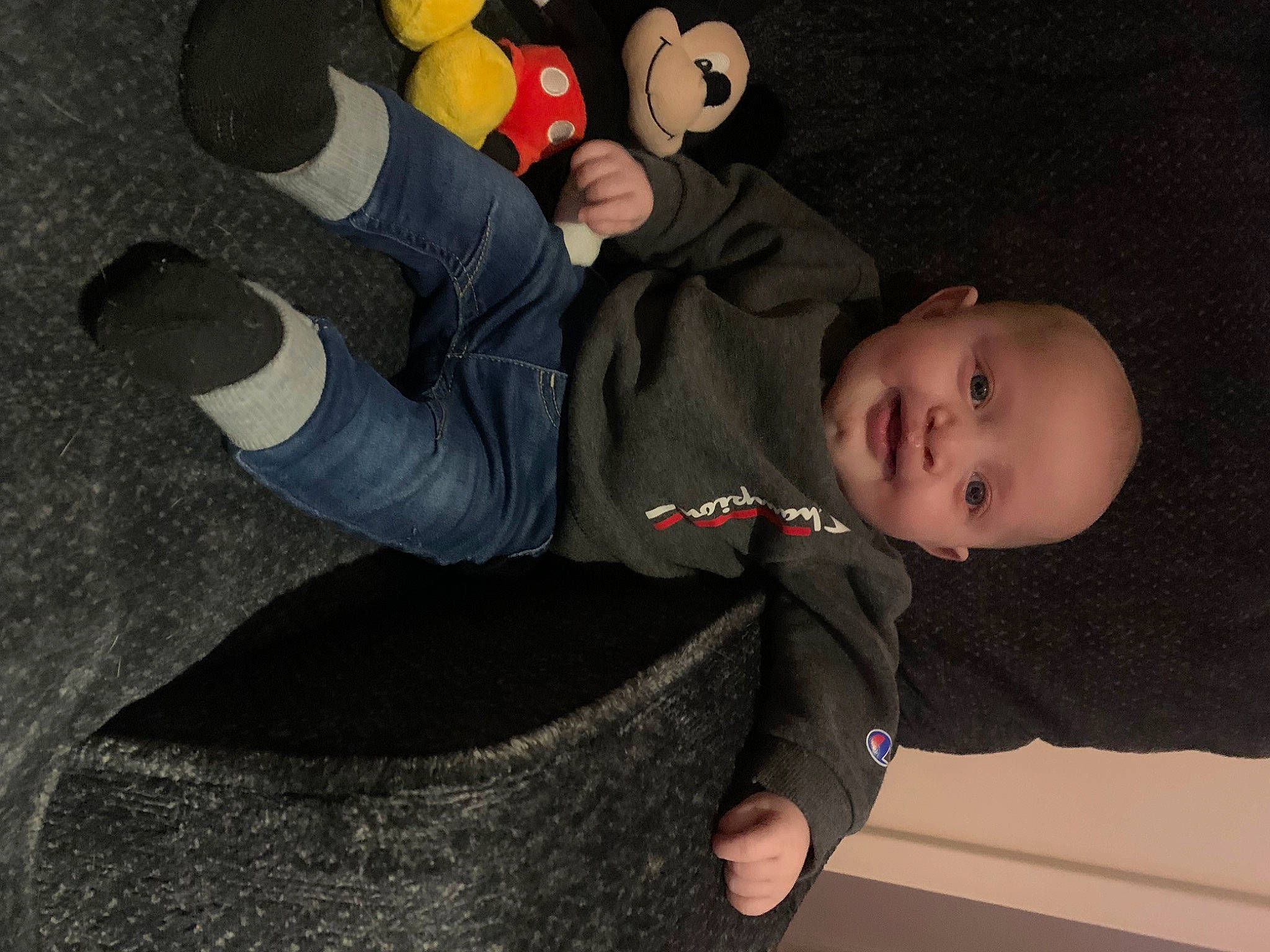 Noah is registered to the contest to win money with this photo: baby, baby_toddler_clothing, child, comfort, facial_expression, finger, flooring, fun, gesture, human_leg, knee, person, room, sitting, sleeve, stuffed_toy, thumb, toddler, toy