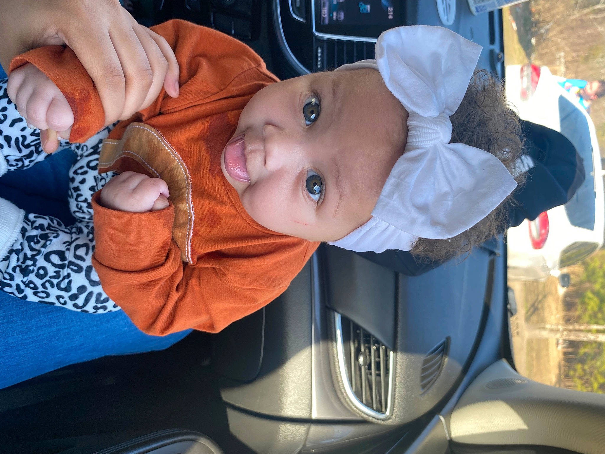 Jaylani is registered to the contest to win money with this photo: auto_part, automotive_exterior, baby, baby_carriage, baby_products, baby_toddler_clothing, car_seat, cheek, child, fun, hat, headwear, motor_vehicle, mouth, nail, person, plant, smile, thumb, toddler