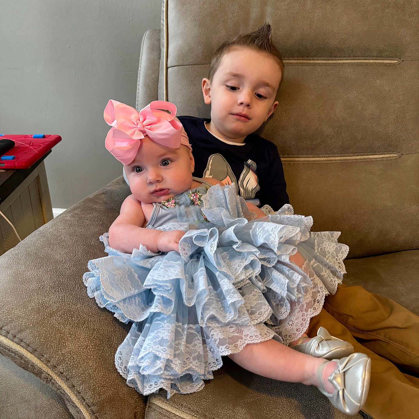 Riley is registered to the contest to win money with this photo: baby, blanket, chair, clothing, couch, cushion, dress, face, footwear, furniture, hat, head, homedecor, newborn, people, person, photography, portrait, shoe, sitting