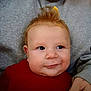 baby, child, face, smile, red_sweater, hair, mohawk_style, skin, eyes, person, portrait, infant, cute, cheeks, expression, cozy, warm_clothing, indoor, adult_arm, holding