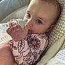Aurora is registered to the contest to win money with this photo: baby, infant, bottle, feeding, blue_eyes, pink_clothing, patterned_outfit, cushion, seat, closeup, hand, soft_lighting, indoor, comfort, child, young, portrait, cute, resting, peaceful