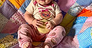 Aurora joined the competition — help win amazing prizes! baby, child, cookie, snack, colorful_quilt, patchwork, sitting, pink_clothing, cute, happy, blue_eyes, indoor, food, stack, playful, infant, hand, foot, smile, portrait
