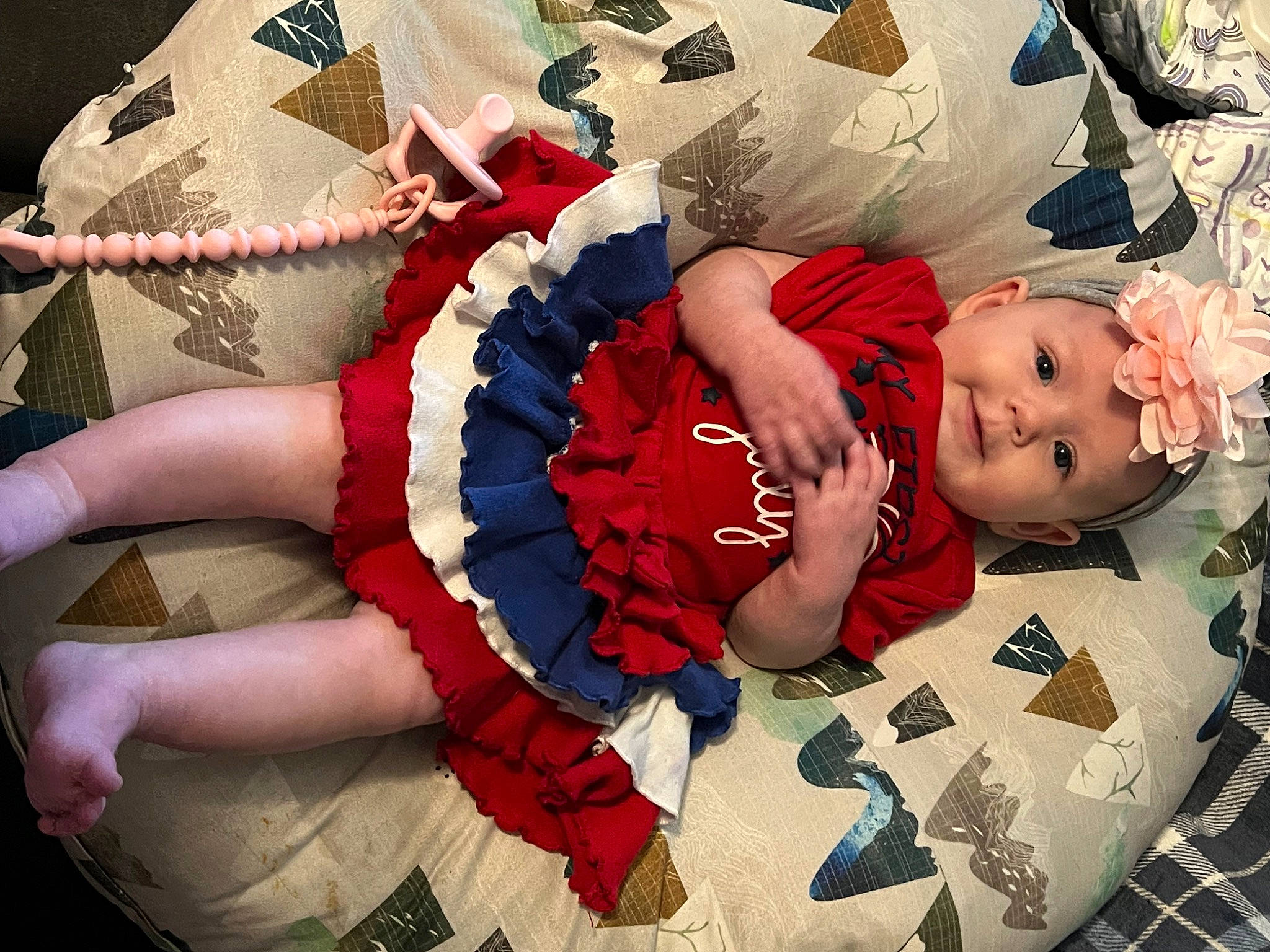 Novalee is registered to the contest to win money with this photo: baby, baby_products, baby_toddler_clothing, carmine, child, comfort, fashion_accessory, finger, fun, gesture, happy, headwear, human_leg, linens, pattern, person, pink, sitting, t_shirt, textile