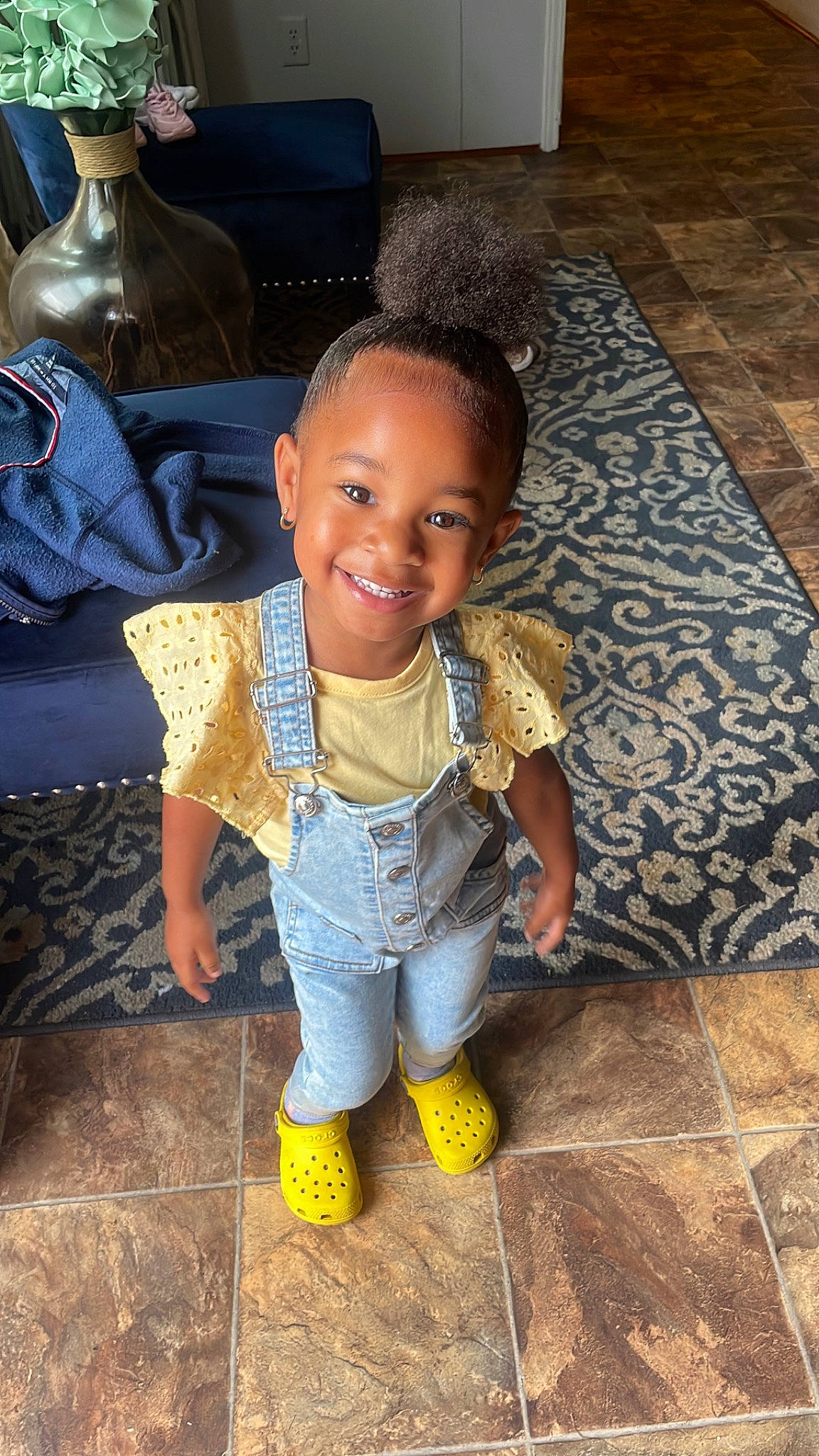 Alaiyah is registered to the contest to win money with this photo: baby_toddler_clothing, chair, cheek, child, cool, facial_expression, floor, flooring, fun, hair, happy, head, human_leg, joy, person, room, sitting, skin, smile, temple