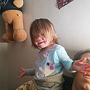 Aliveah is registered to the contest to win money with this photo: child, adult, smile, hair, unicorn_shirt, pants, stuffed_bear, wall, photo, indoor, person, joy, playful, family, casual, home, portrait, happy, childhood, fun