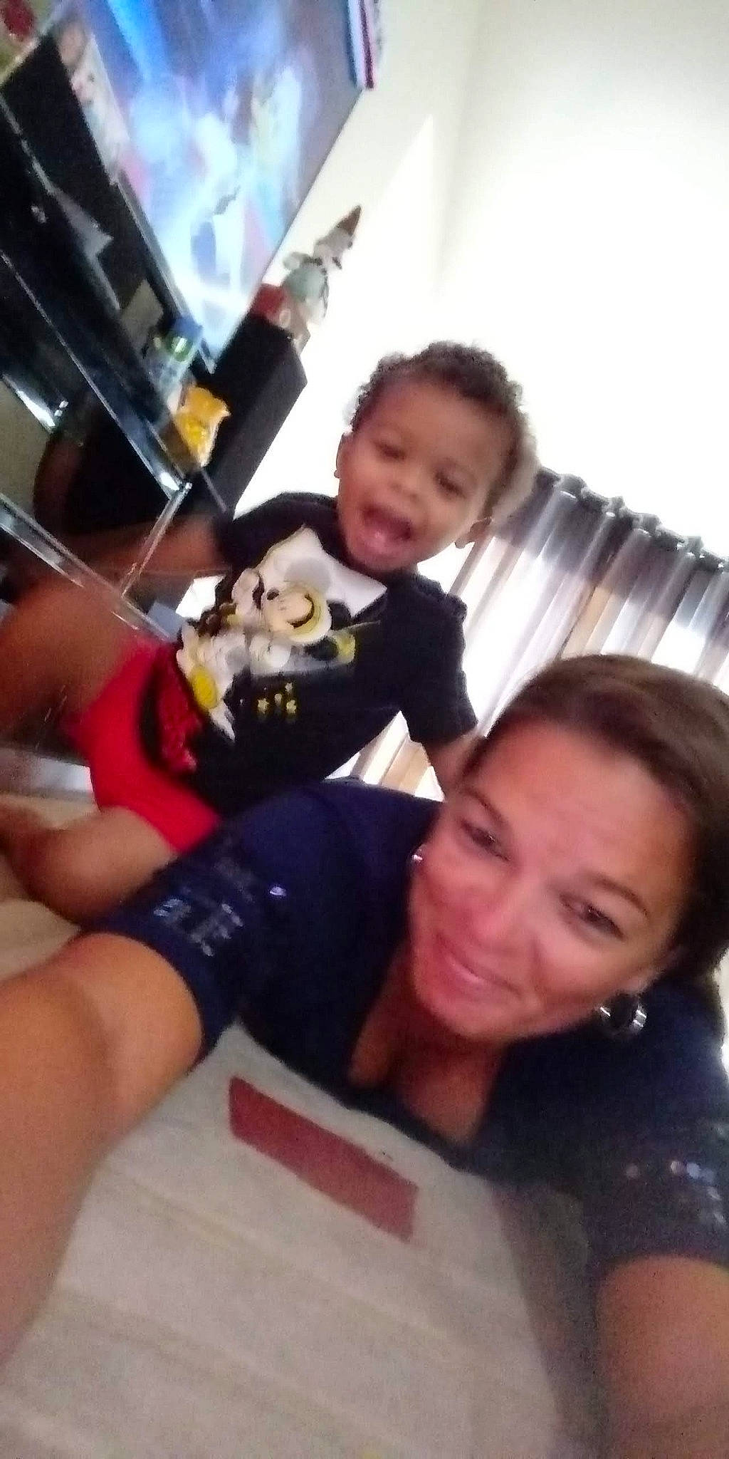 Malachi is registered to the contest to win money with this photo: black_hair, child, elbow, event, fun, gesture, happy, joy, leisure, person, room, selfie, sitting, smile, t_shirt, thigh, vacation