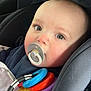 Hugo joined the competition — help win amazing prizes! baby, car_interior, car_seat, child, closeup, clothing, colorful, cute, eyes, face, head, indoors, infant, pacifier, seatbelt, sitting, skin, teething_rings, toy, young_child