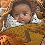 Elena a rejoint le concours — aidez-le/la à gagner de superbes lots ! baby, blanket, face, person, infant, portrait, wrapped, quilted, yellow, soft, cozy, cute, child, indoor, warm, clothing, expression, looking, closeup, head