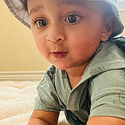 Harvin is registered to the contest to win money with this photo: baby, blanket, bucket_hat, candid, child, closeup, clothing, curious, expression, face, hat, indoor, light, person, portrait, skin, soft_light, toddler, window, young_child