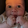 Grayson joined the competition — help win amazing prizes! baby, close_up, chubby_cheeks, curious_eyes, infant, cute, white_shirt, wooden_buttons, hands, fingers, nibbling, portrait, child, soft_lighting, indoor, skin, face, expression, young, person