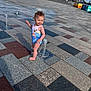 Nala joined the competition — help win amazing prizes! toddler, child, swimsuit, water_jet, outdoor, play, sunny, shadow, plaza, tiles, people, daytime, happy, barefoot, sky, clouds, fountain, water, fun, summer