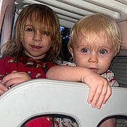 River is registered to the contest to win money with this photo: child, children, pajamas, play_structure, indoor, blonde_hair, brown_hair, curious, blue_eyes, face, hand, closeup, person, cute, toddler, sibling, plastic, playtime, smiling, fun