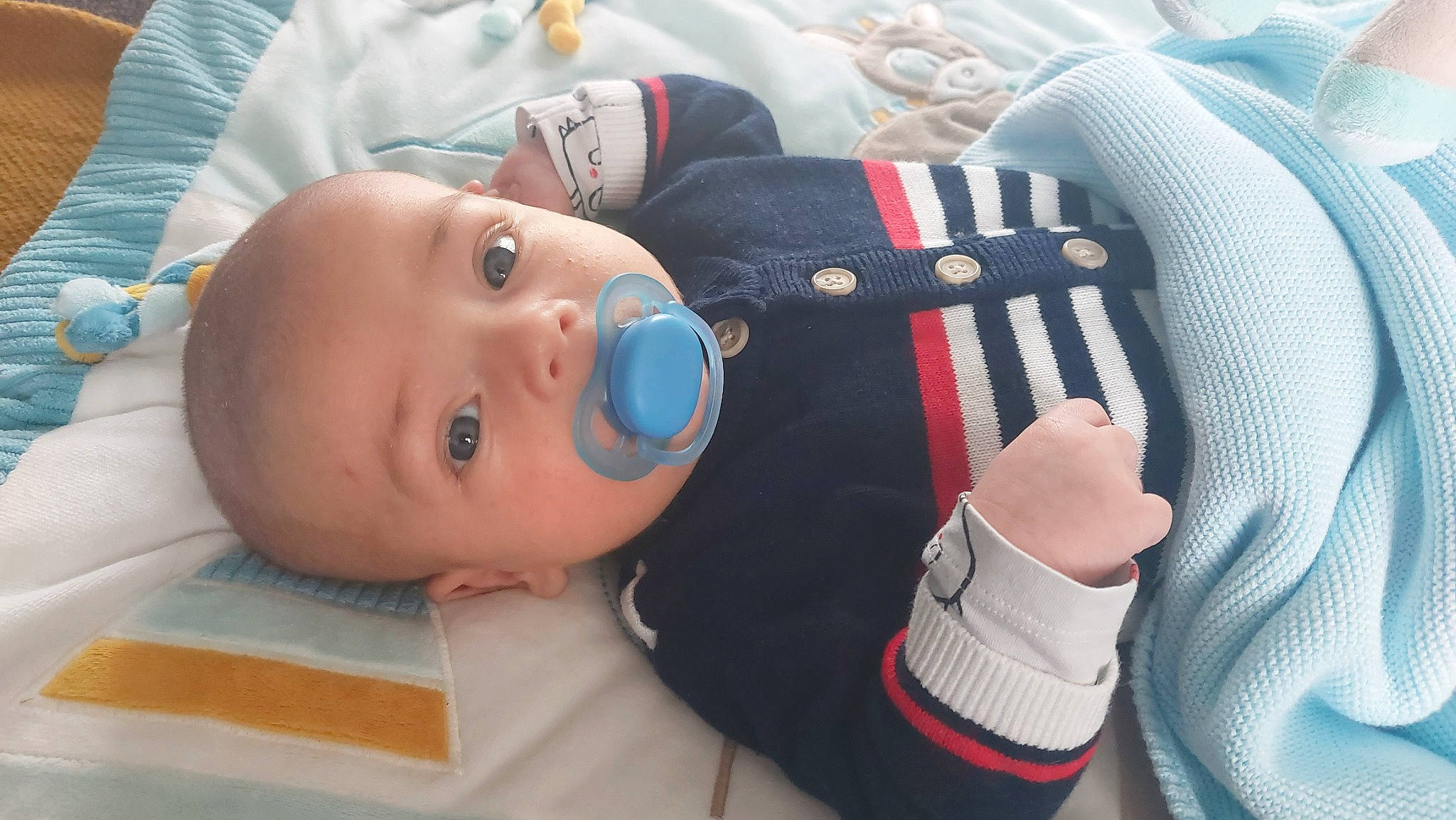 Ethan participe au concours pour gagner de l'argent avec cette photo : baby, baby_products, baby_safety, baby_toddler_clothing, cheek, child, comfort, electric_blue, gesture, linens, nail, person, product, sleeve, thumb, toddler, white, wrist