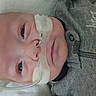 baby, infant, nasal_tube, oxygen_tube, medical_device, lying_down, grey_clothing, animal_patch, close_up, face, head, skin, eyes, person, indoors, healthcare, newborn, cute, patient, hospital