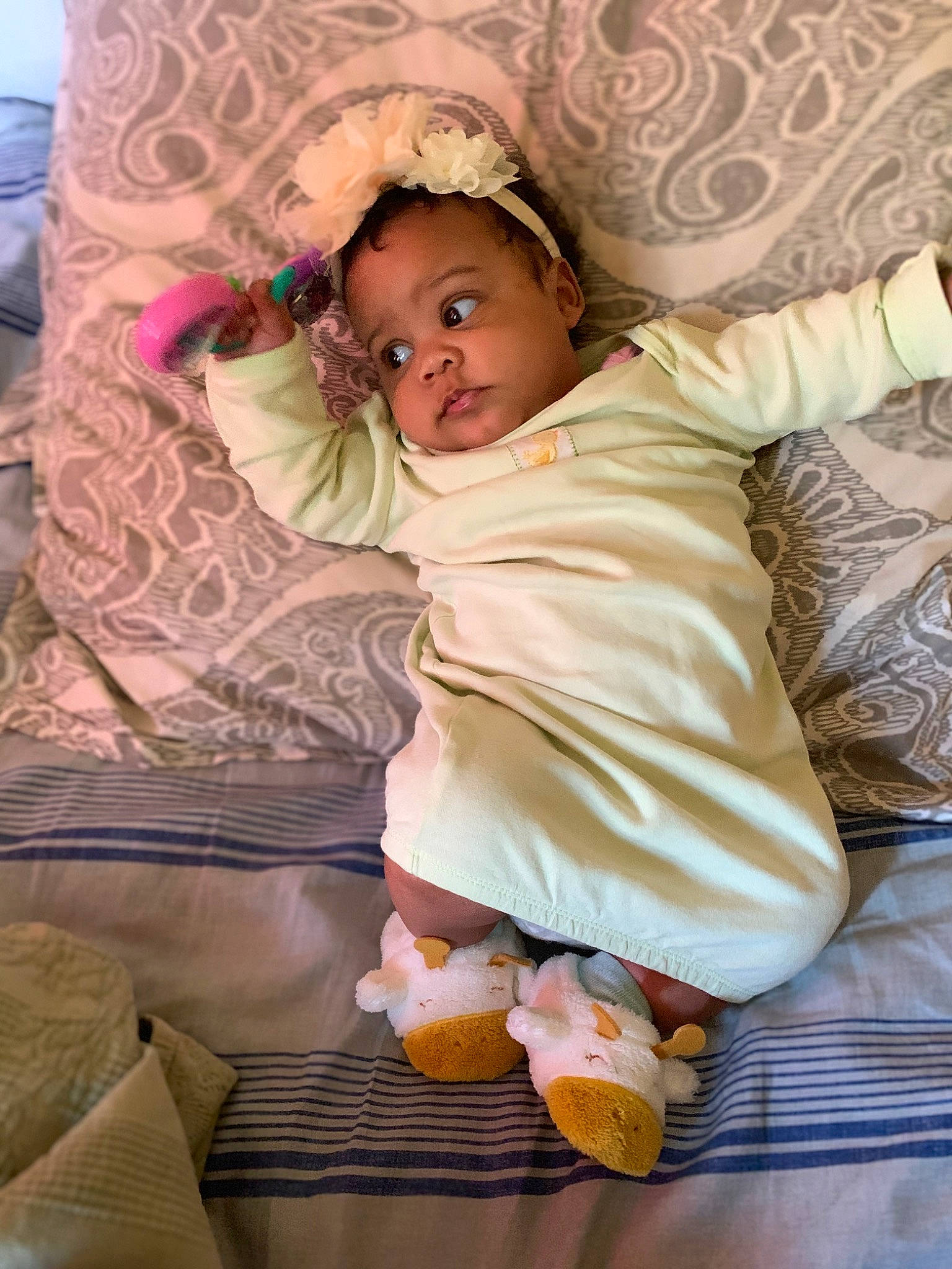 Molly is registered to the contest to win money with this photo: baby, baby_products, baby_toddler_clothing, cheek, child, comfort, fashion_accessory, fun, happy, head, linens, magenta, pattern, person, pink, play, purple, room, sitting, sleeve