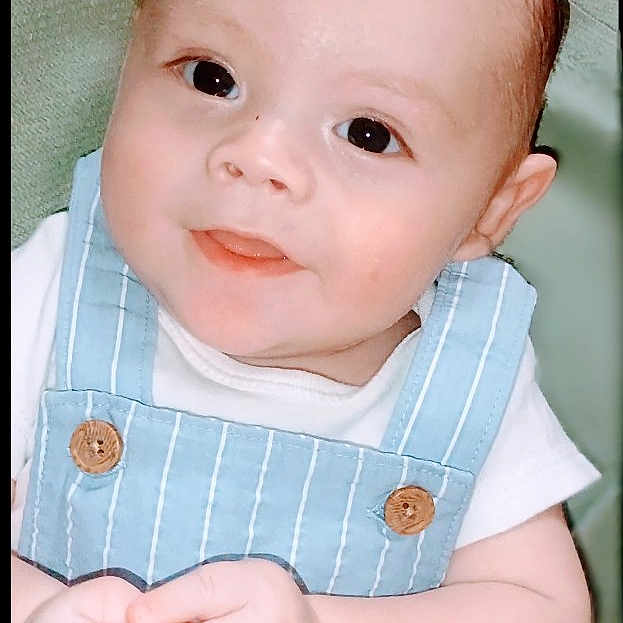 Amiri joined the competition — help win amazing prizes! baby, child, infant, face, hands, blue_overall, white_shirt, smile, cute, portrait, skin, eyes, hair, indoors, soft_light, closeup, expression, happy, young, background