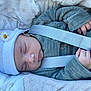 baby, sleeping, hat, flower, car_seat, seatbelt, blanket, cozy, infant, child, clothing, hand, peaceful, cute, soft, portrait, rest, newborn, closeup, outdoor