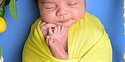 Yacine a rejoint le concours — aidez-le/la à gagner de superbes lots ! baby, newborn, wrapped, yellow_blanket, sleeping, face, hands, feet, green_leaves, lemons, fruit, blue_background, portrait, cute, peaceful, infant, soft_light, wood_surface, knotted_rope, indoors