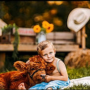 Asher joined the competition — help win amazing prizes! child, boy, calf, cow, animal, grass, farm, sunflowers, bench, hay_bale, cowboy_hat, outdoor, portrait, blue_eyes, denim, barefoot, cuddling, smile, bokeh, rural