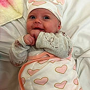 Charlotte is registered to the contest to win money with this photo: baby, bed, blanket, bodypart, bonnet, cap, clothing, face, finger, furniture, glove, hand, hat, head, newborn, person, photography, portrait, quilt, sleeping