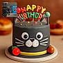 Koda Bear joined the competition — help win amazing prizes! cake, birthday, cat_theme, fondant, colorful, decorations, celebration, animal_face, gray_cat, whiskers, ears, round_cake, party, food, dessert, cute, small_photo_inset, background_blur, table, festive