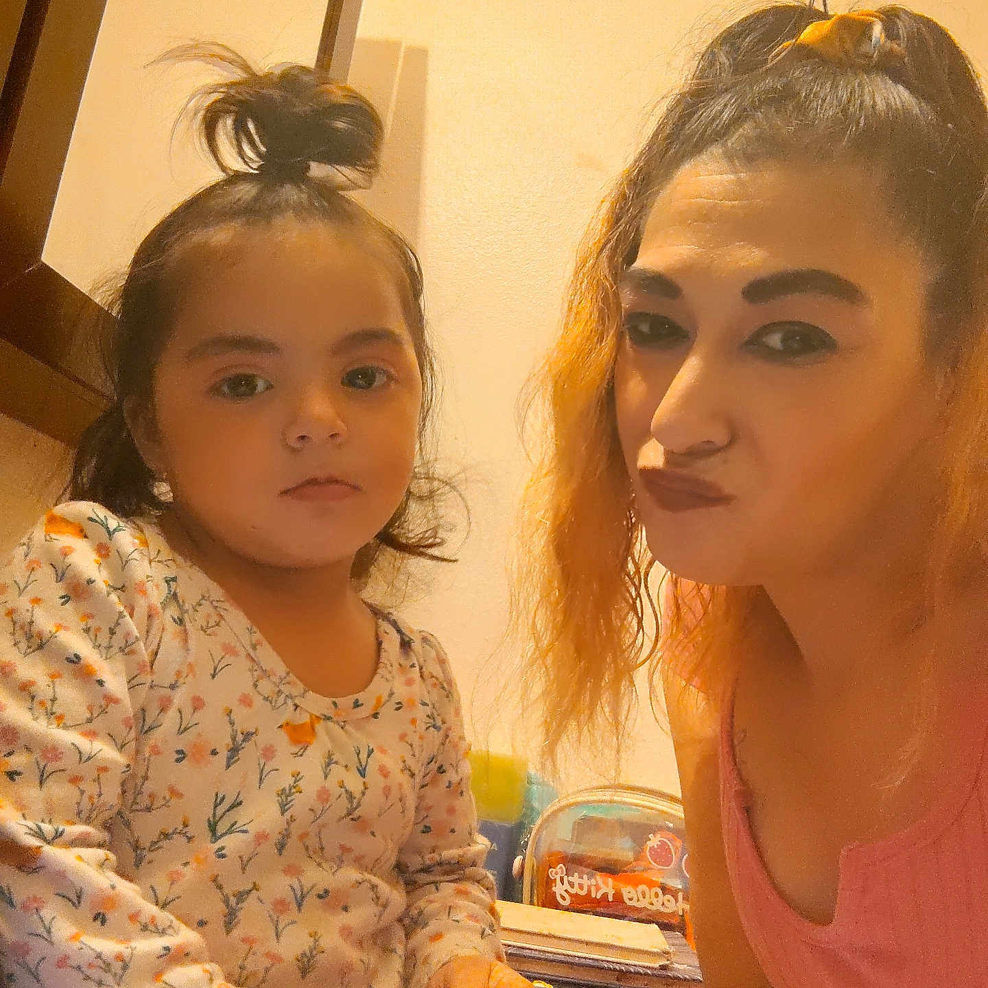 Armanie is registered to the contest to win money with this photo: adult_female, calm, casual, child, closeup, expression, family, floral_clothing, hair_tied, hand, indoor, person, playful, portrait, pout, skin_tone, snapshot, warm_lighting, woman, young_girl