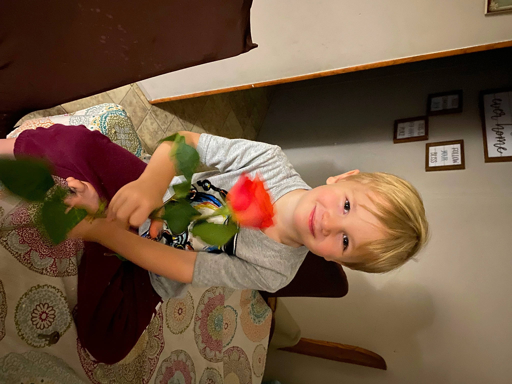 R J is registered to the contest to win money with this photo: abdomen, arm, baby, baby_products, chair, child, comfort, couch, elbow, fun, happy, human_leg, joy, pattern, person, picture_frame, plant, room, sitting, smile