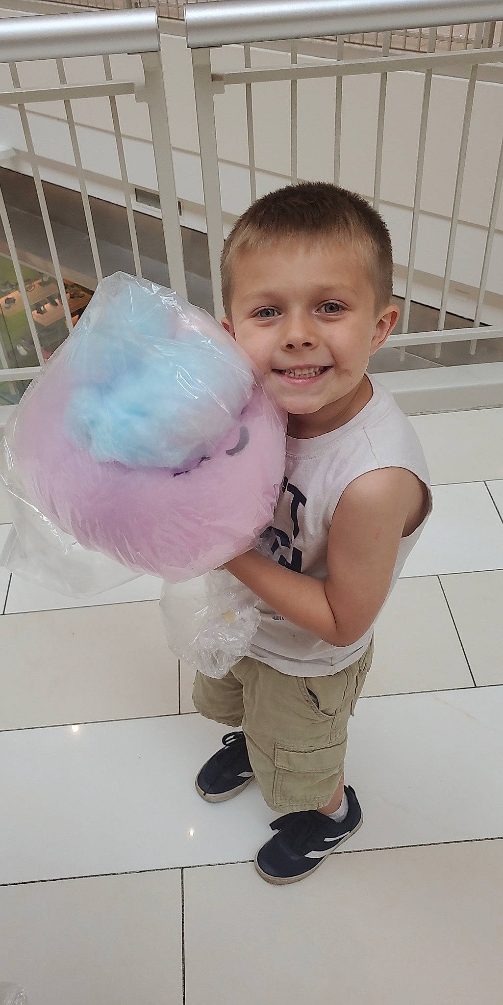 Ricky is registered to the contest to win money with this photo: baby, baby_toddler_clothing, child, cotton_candy, face, flooring, fun, fur, happy, joy, party_supply, person, plastic_bag, play, sandal, sleeve, smile, sock, stuffed_toy, teddy_bear