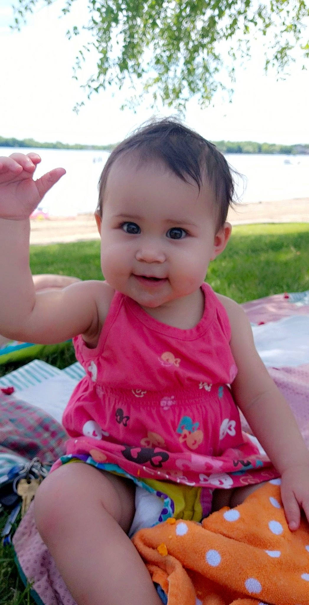 Raelynn is registered to the contest to win money with this photo: baby, baby_toddler_clothing, cheek, child, finger, fun, gesture, grass, happy, leisure, magenta, nose, person, pink, sitting, skin, sky, smile, summer, thumb